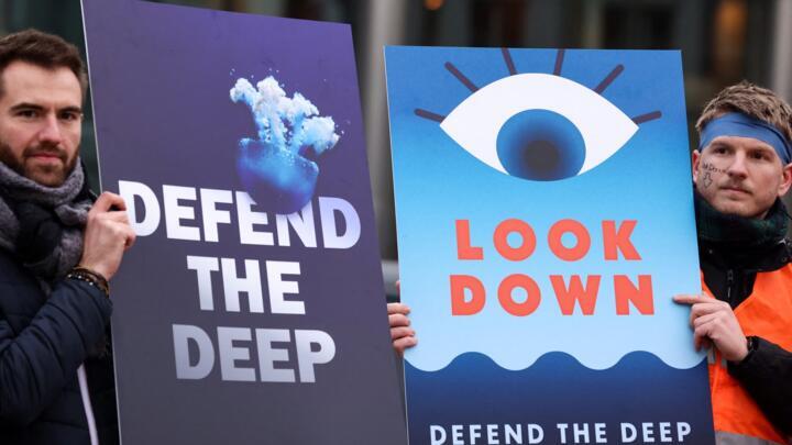 Activists take part at a "Look Down action" rally to stop deep sea mining outside the European Parliament in Brussels on March 6, 2023.
